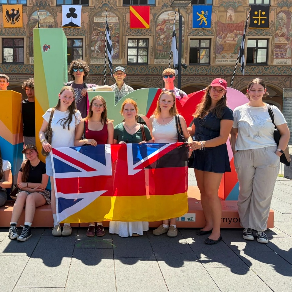 Students standing outside with UK and German flags